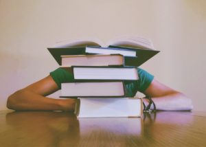 lady with books close to her head