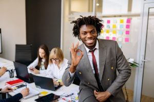 employee showing "okay" sign